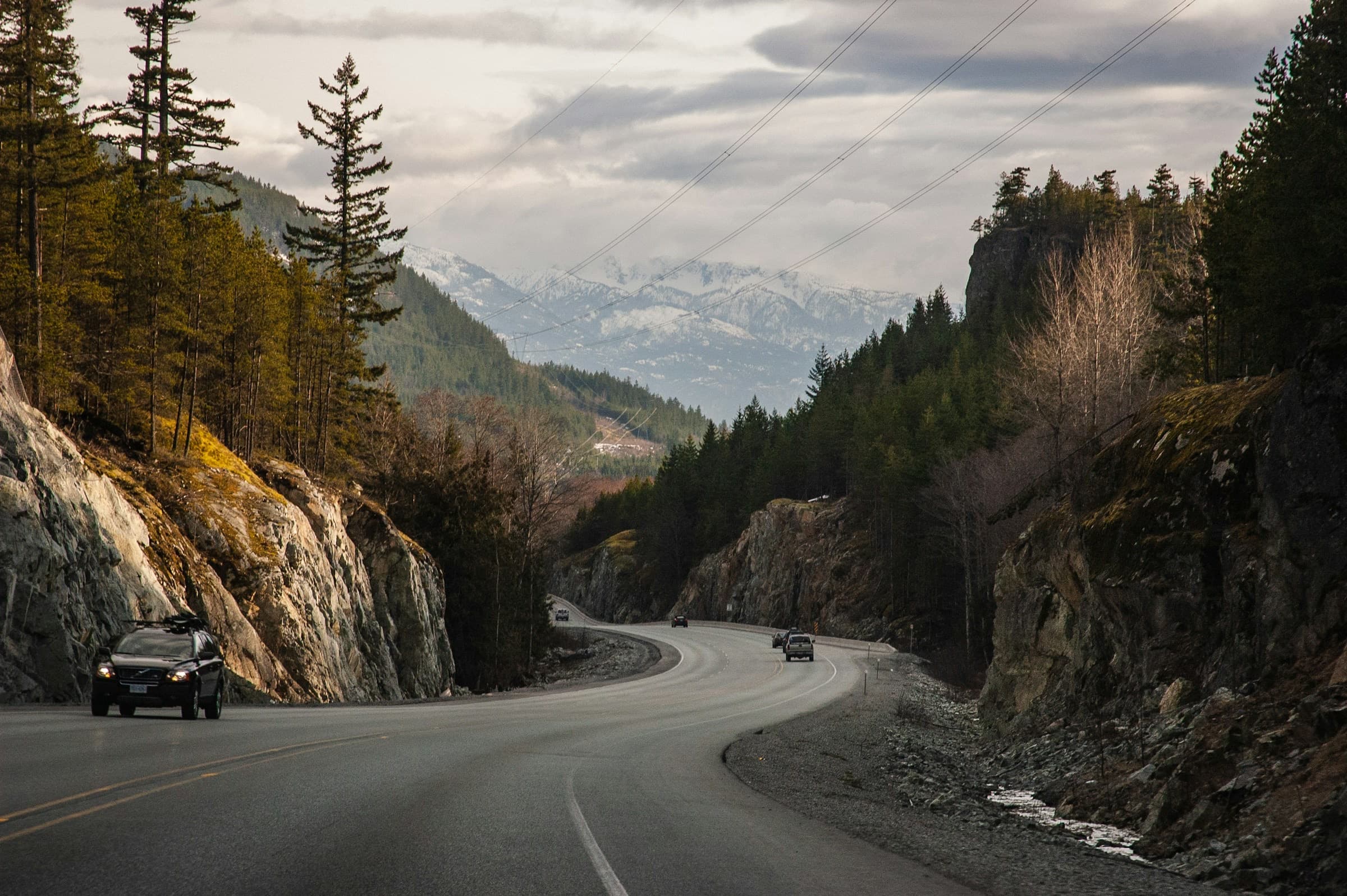 The Sea to Sky Highway curving between rock cuts and forest