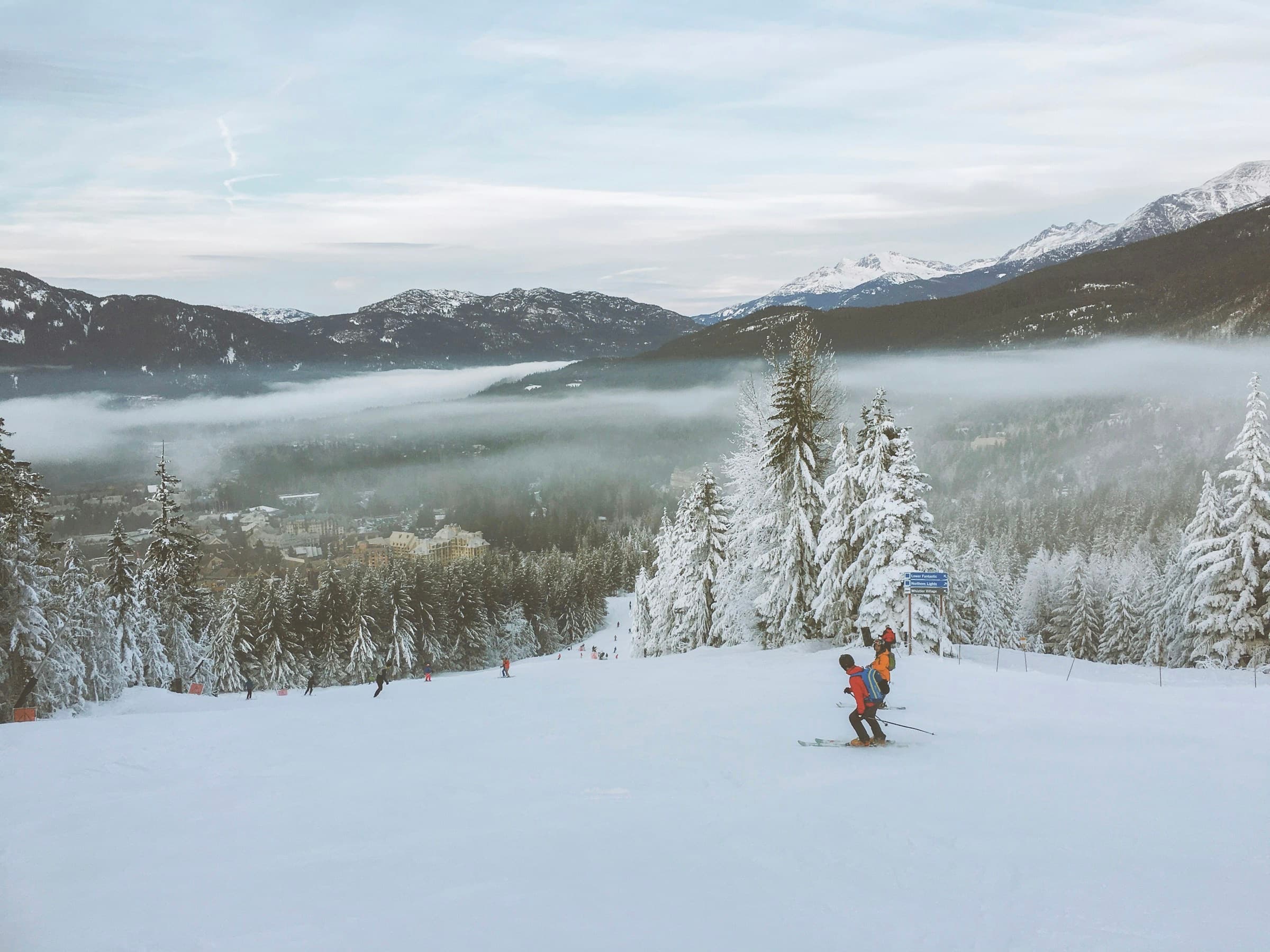 A skier on a quiet run above valley cloud at Whistler Blackcomb